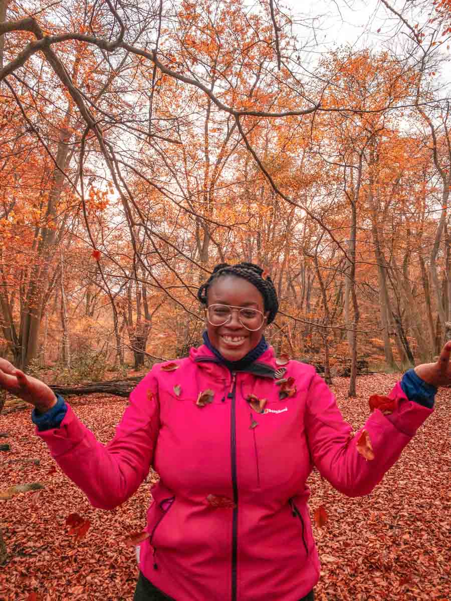 Julianna Barnaby standing among the autumn beeches in Epping Forest