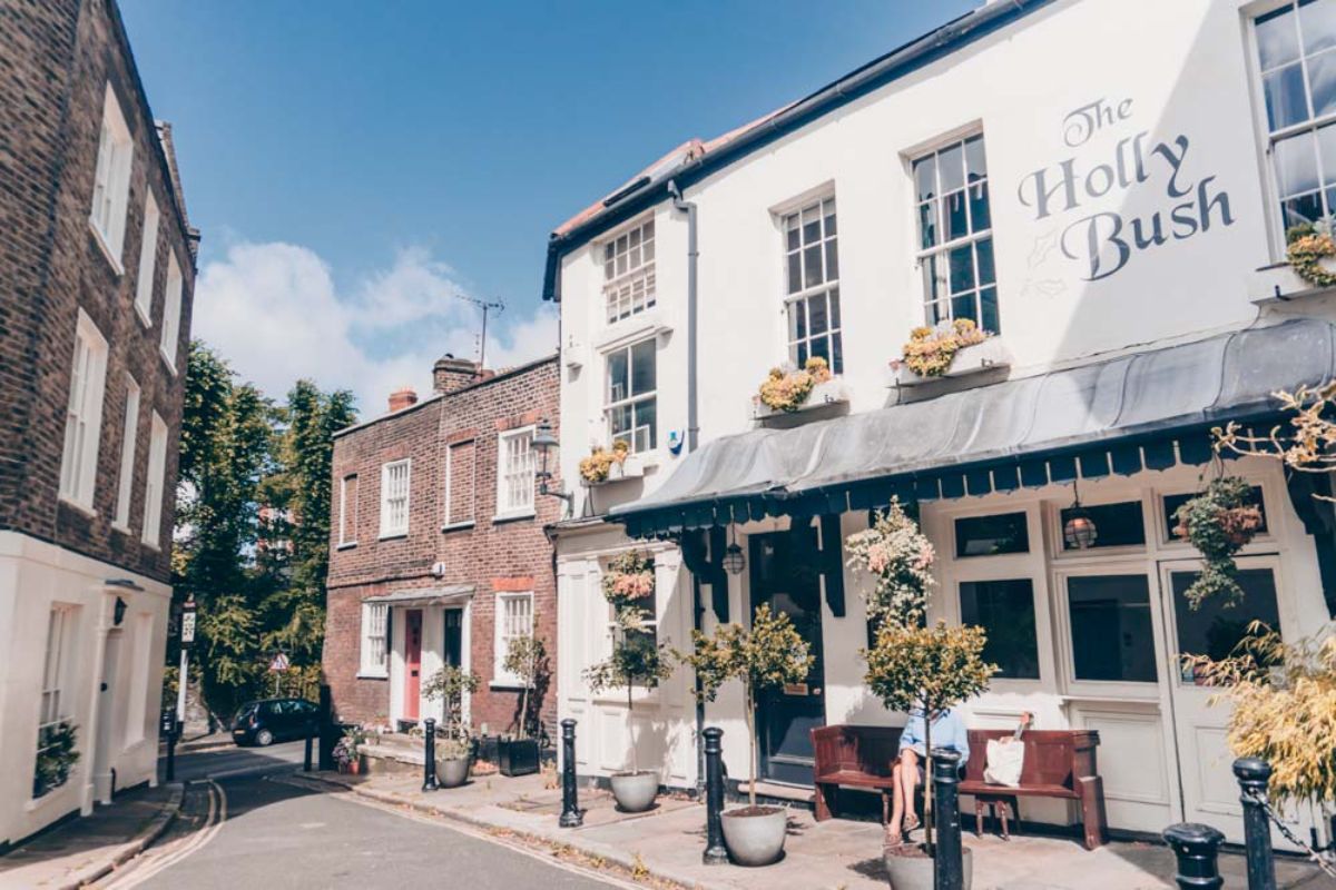 The Holly Bush pub in Hampstead, its painted sign above the frontage on the lane at Hollymount