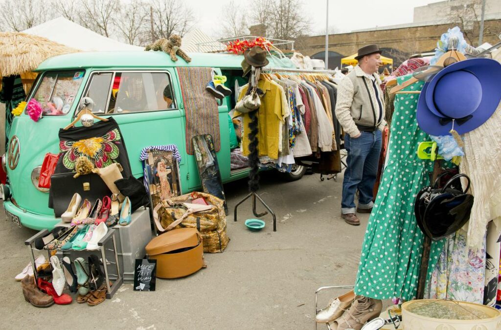 Open camper van with vintage items for sale