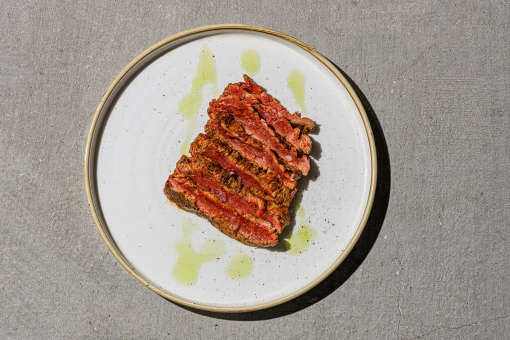 Seared steak on white plate