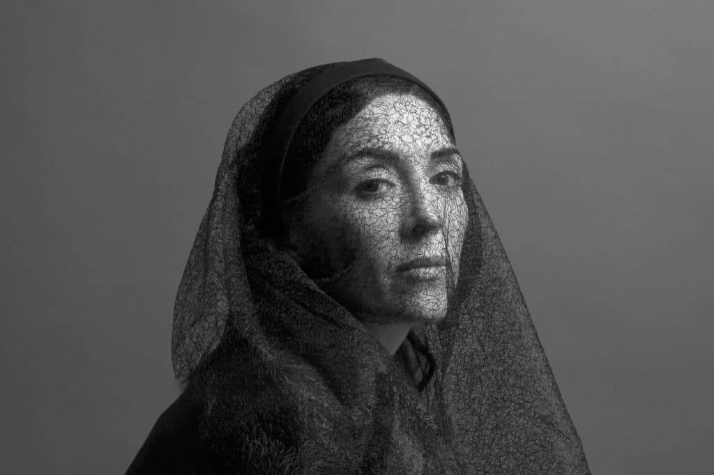 woman with netted headcovering 