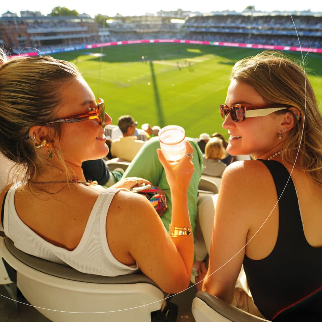 Two girls chatting during the cricket