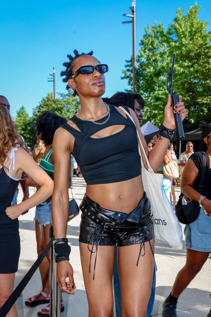 Woman wearing leather shorts and black top 