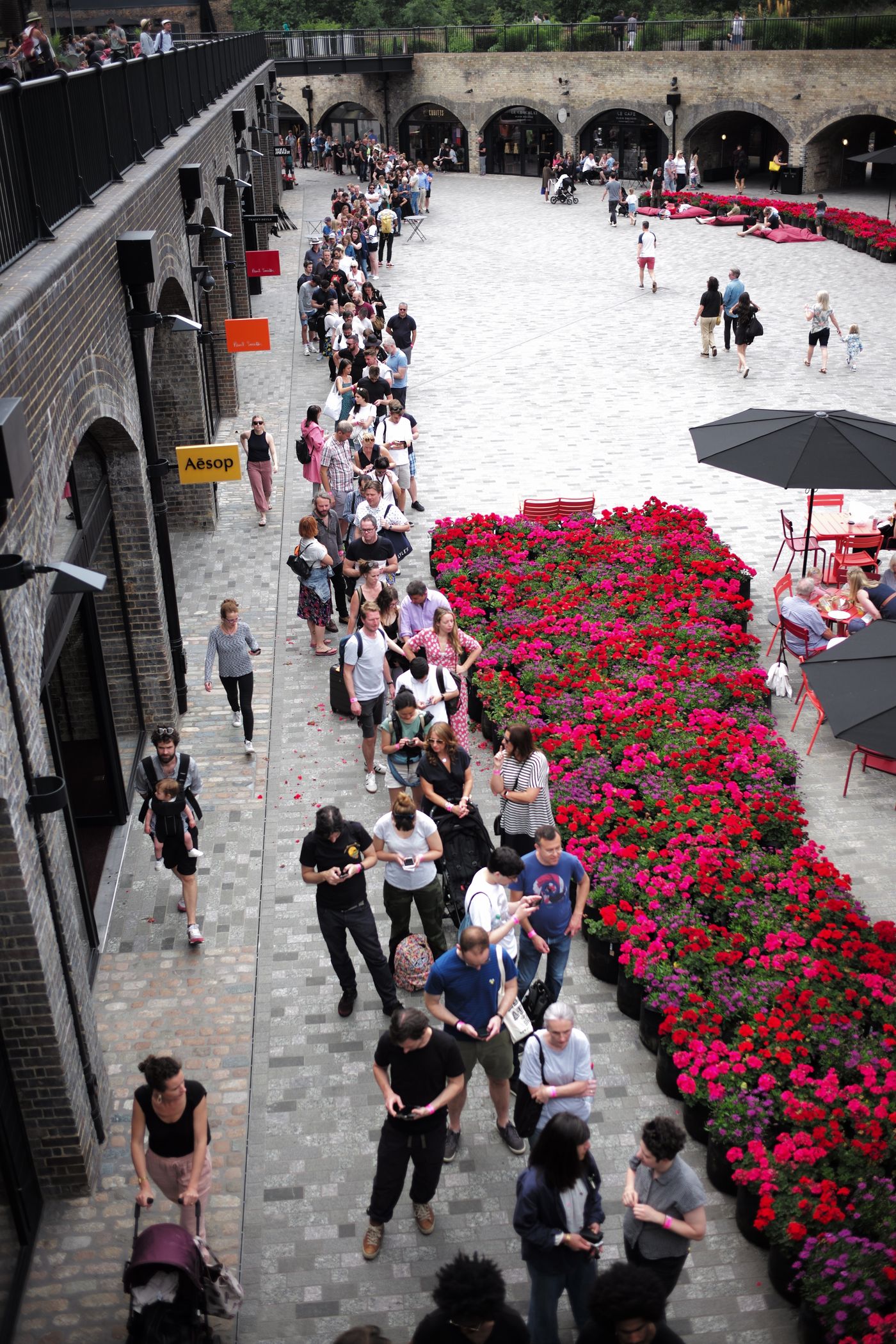 Visitors queuing at the Art Car Boot Fair in King's Cross