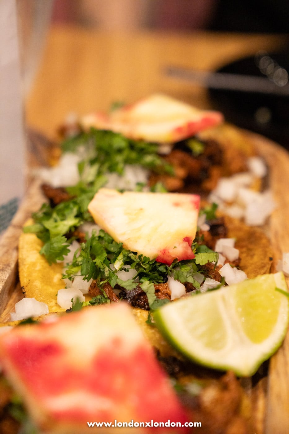 Tacos topped with pineapple, coriander and onion at Chabela in Crystal Palace