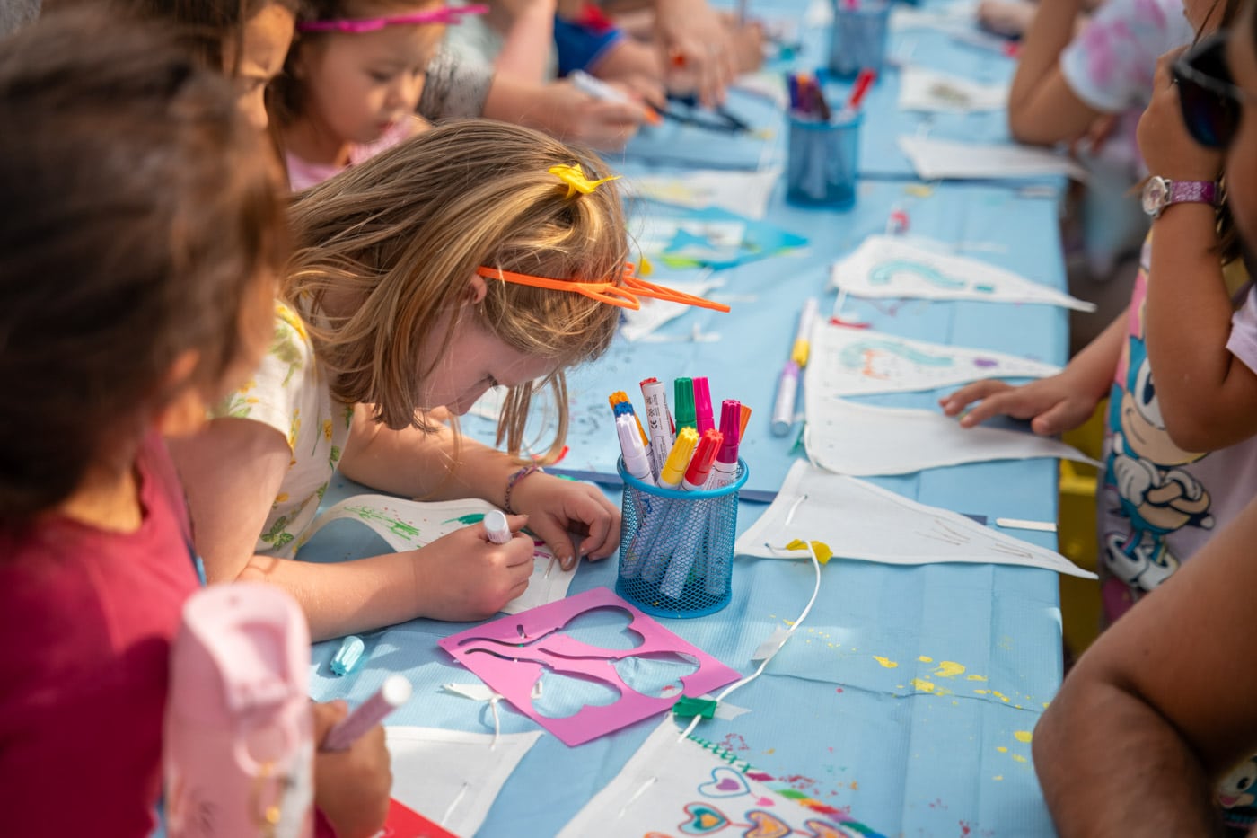 Children making flags and banners at a craft table at the Gabriel's Wharf Arts Festival