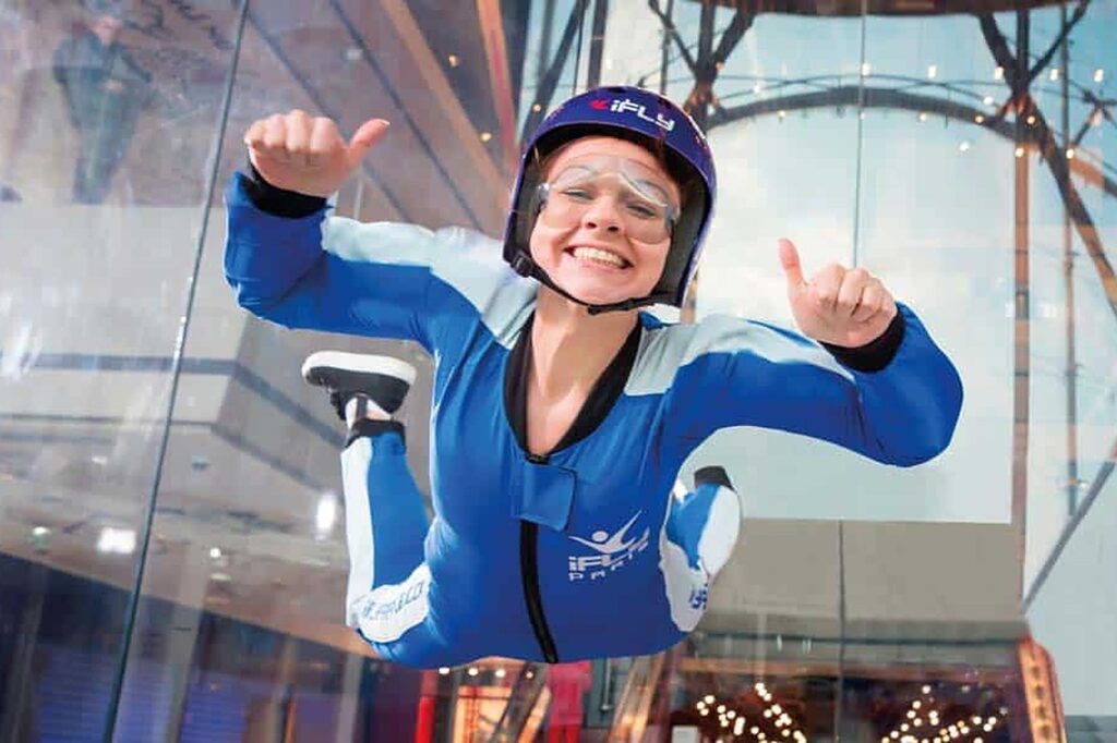 A woman giving a thumbs up while indoor skydiving at iFly in Greenwich
