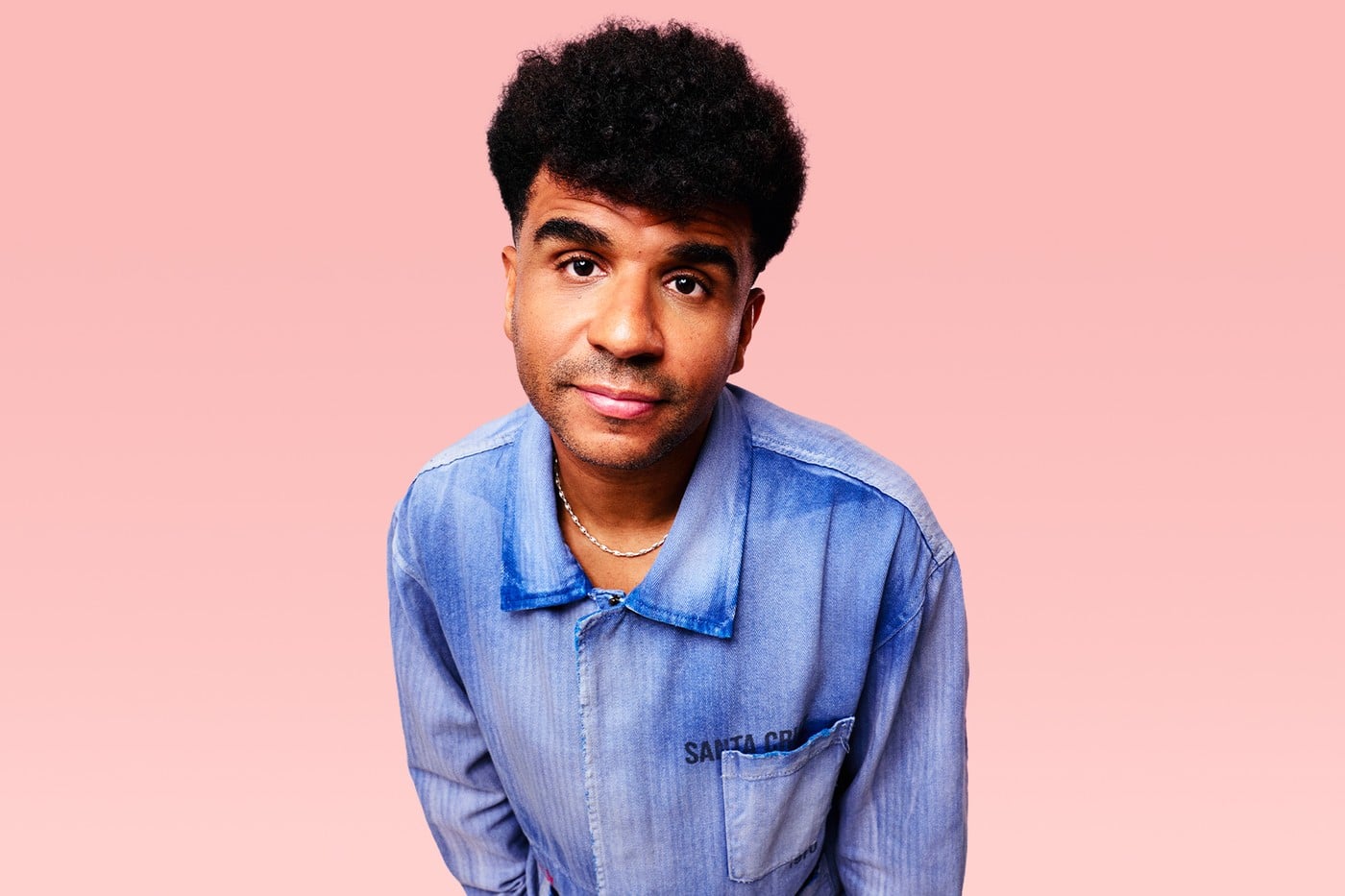 Jamie Jones, DJ and producer, portrait against a pink background