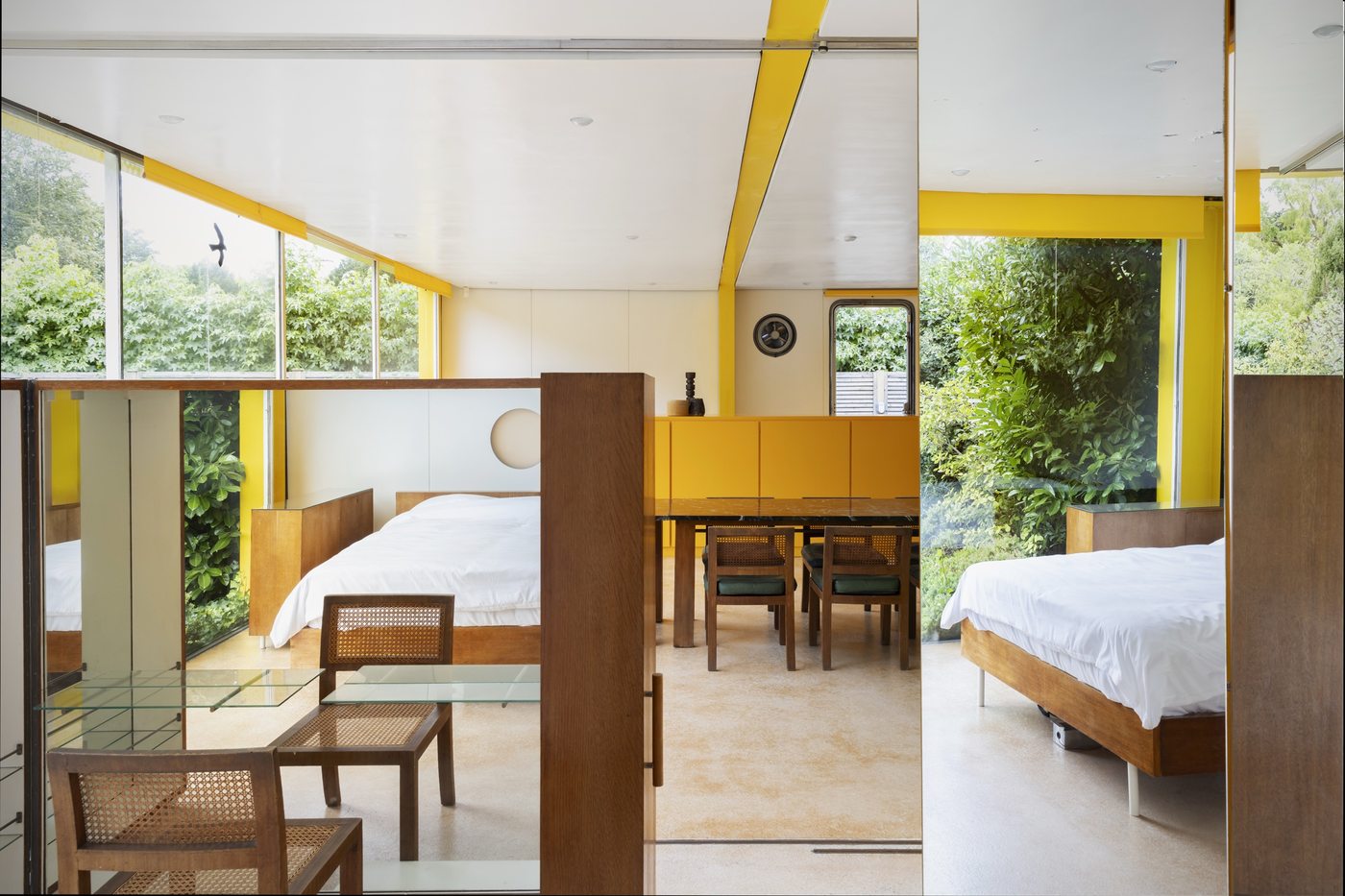 Bedroom and dining space at 22 Parkside, divided by sliding walls rather than structure