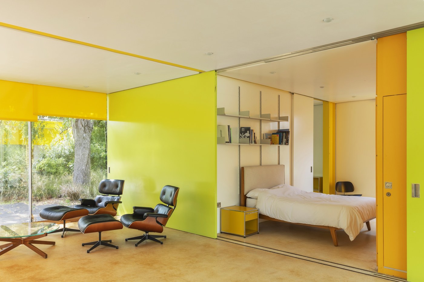 The living room at 22 Parkside, with lime green sliding partitions open to the bedroom