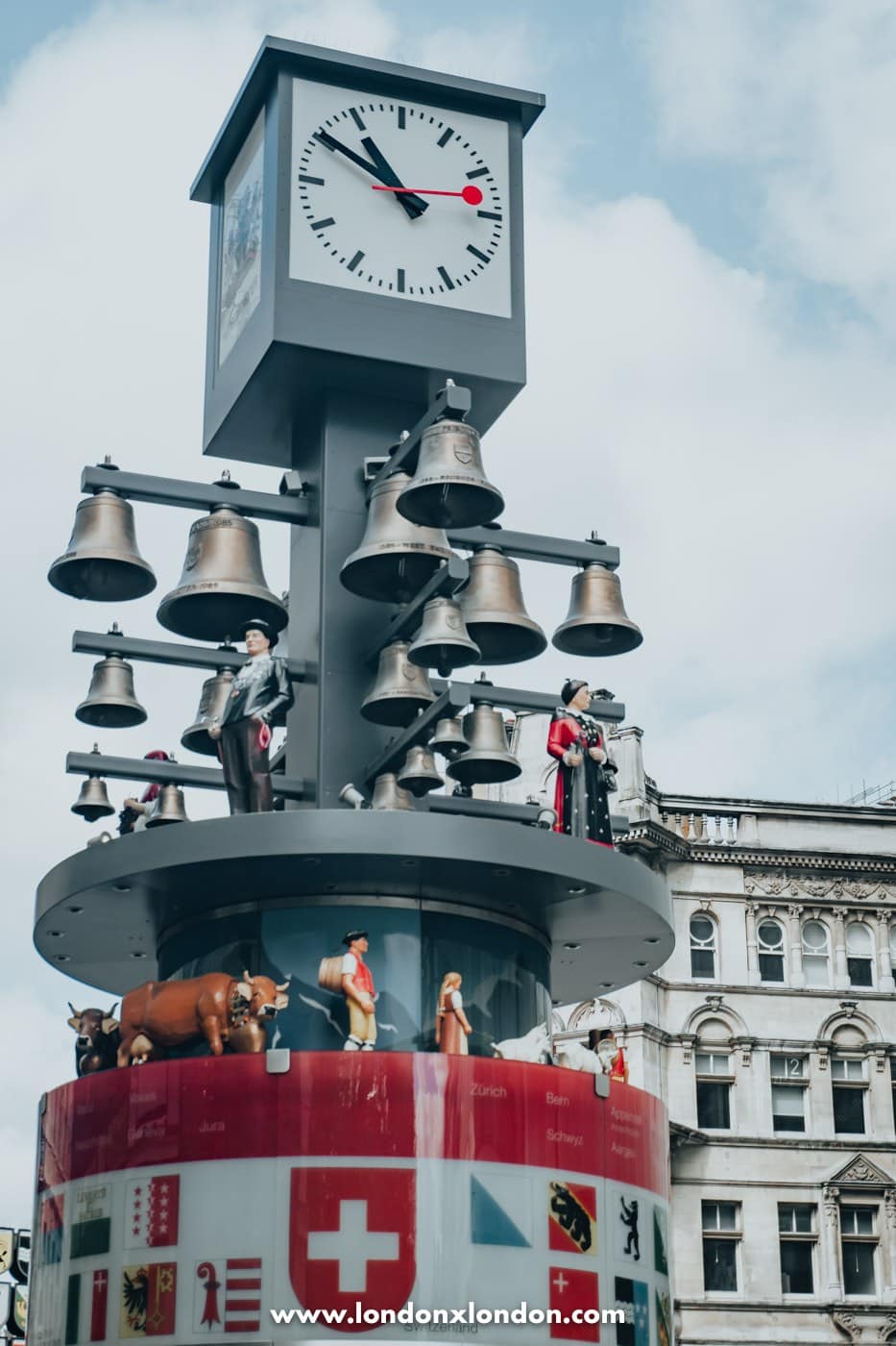 Close view of the Swiss glockenspiel clock face, bells and alpine figures in Swiss Court London